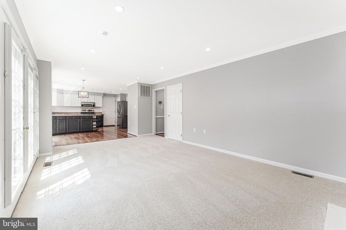 Empty room, Interior, Kitchen, Pendant Lights, Recessed Lighting, Stainless Steel Appliances, Wood Texture Flooring