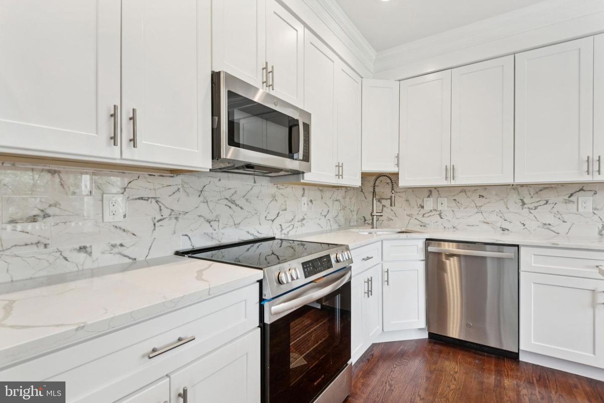 Interior, Kitchen, Marble Walls, Recessed Lighting, Stainless Steel Appliances, Wood Texture Flooring