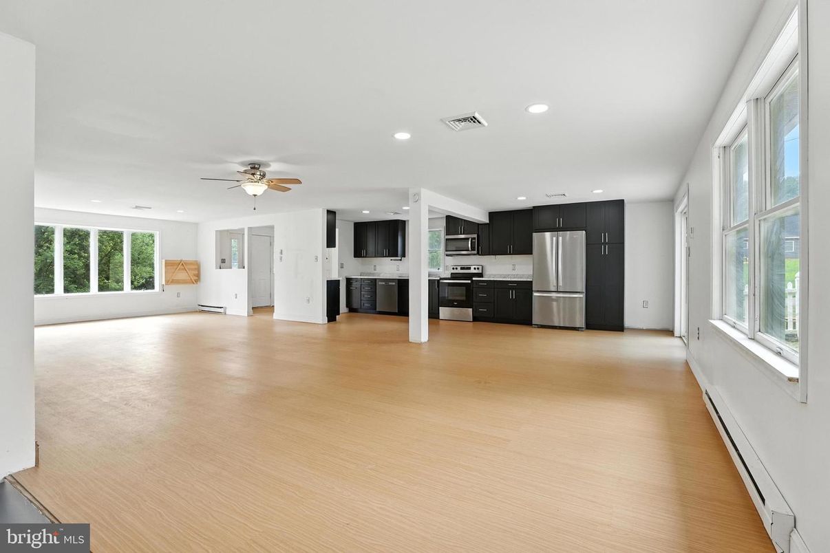 Empty room, Interior, Kitchen, Recessed Lighting, Stainless Steel Appliances, Wood Texture Flooring