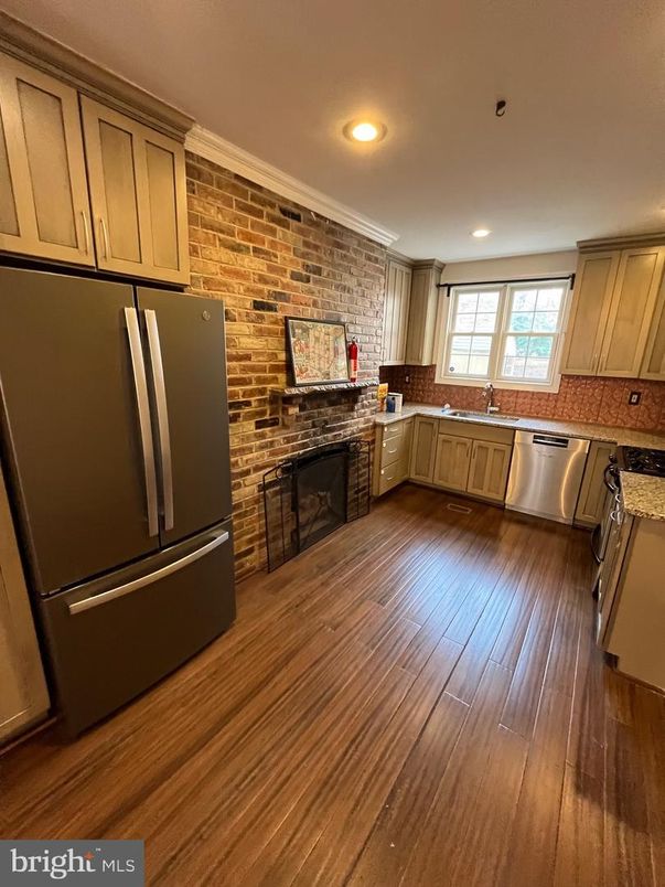 Fireplace, Interior, Kitchen, Recessed Lighting, Stainless Steel Appliances, Stone Walls, Wood Texture Flooring