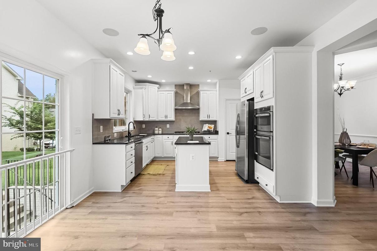 Chandelier, Dining room, Interior, Kitchen, Pendant Lights, Recessed Lighting, Stainless Steel Appliances, Wood Texture Flooring