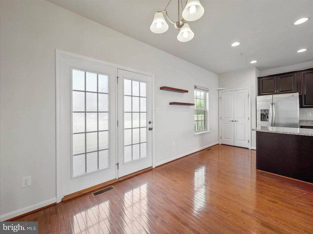 Empty room, Interior, Kitchen, Recessed Lighting, Stainless Steel Appliances, Wood Texture Flooring