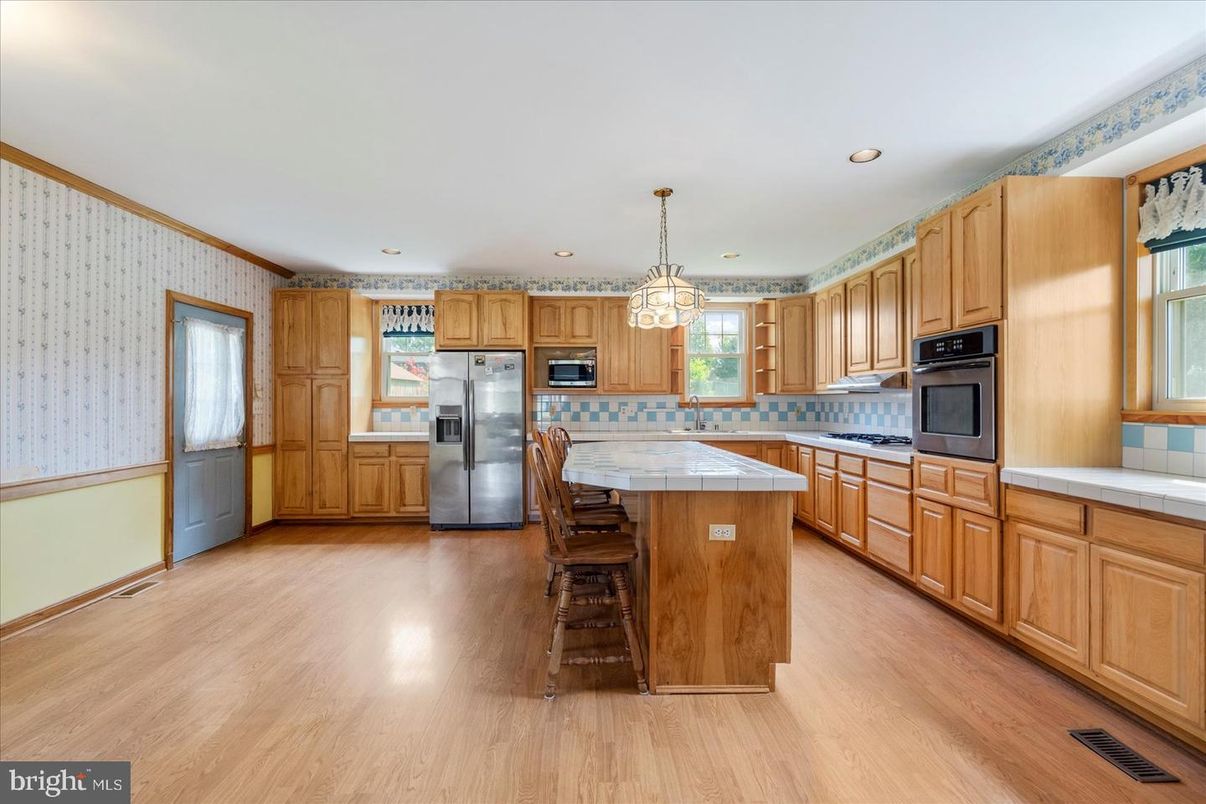 Interior, Kitchen, Pendant Lights, Recessed Lighting, Stainless Steel Appliances, Tile Countertops, Wood Texture Flooring