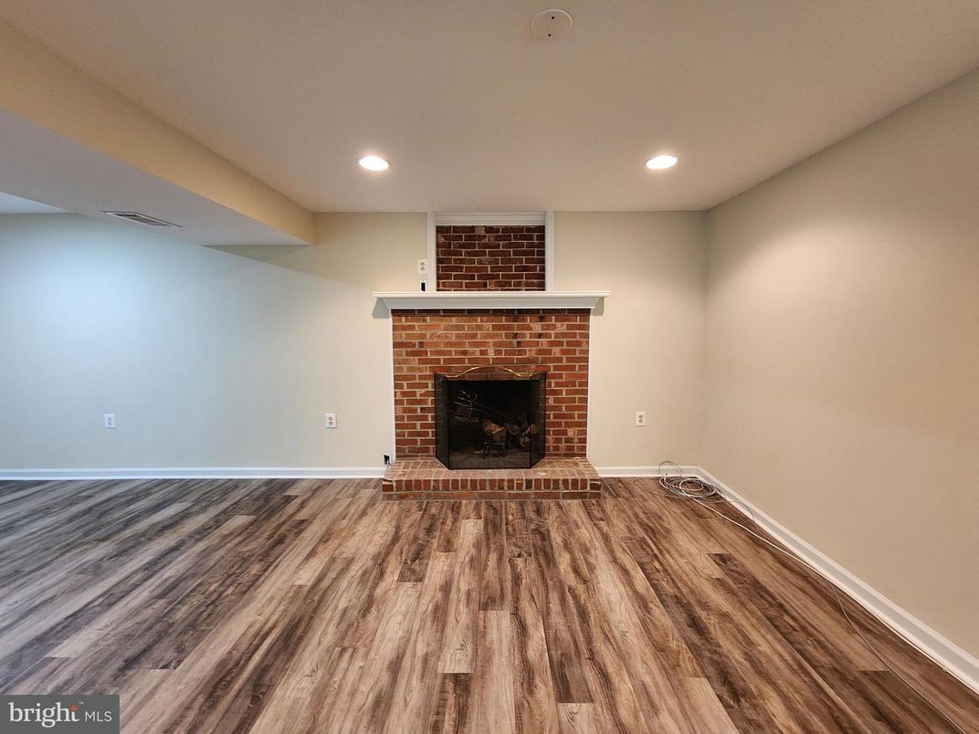 Empty room, Fireplace, Interior, Recessed Lighting, Stone Walls, Wood Texture Flooring