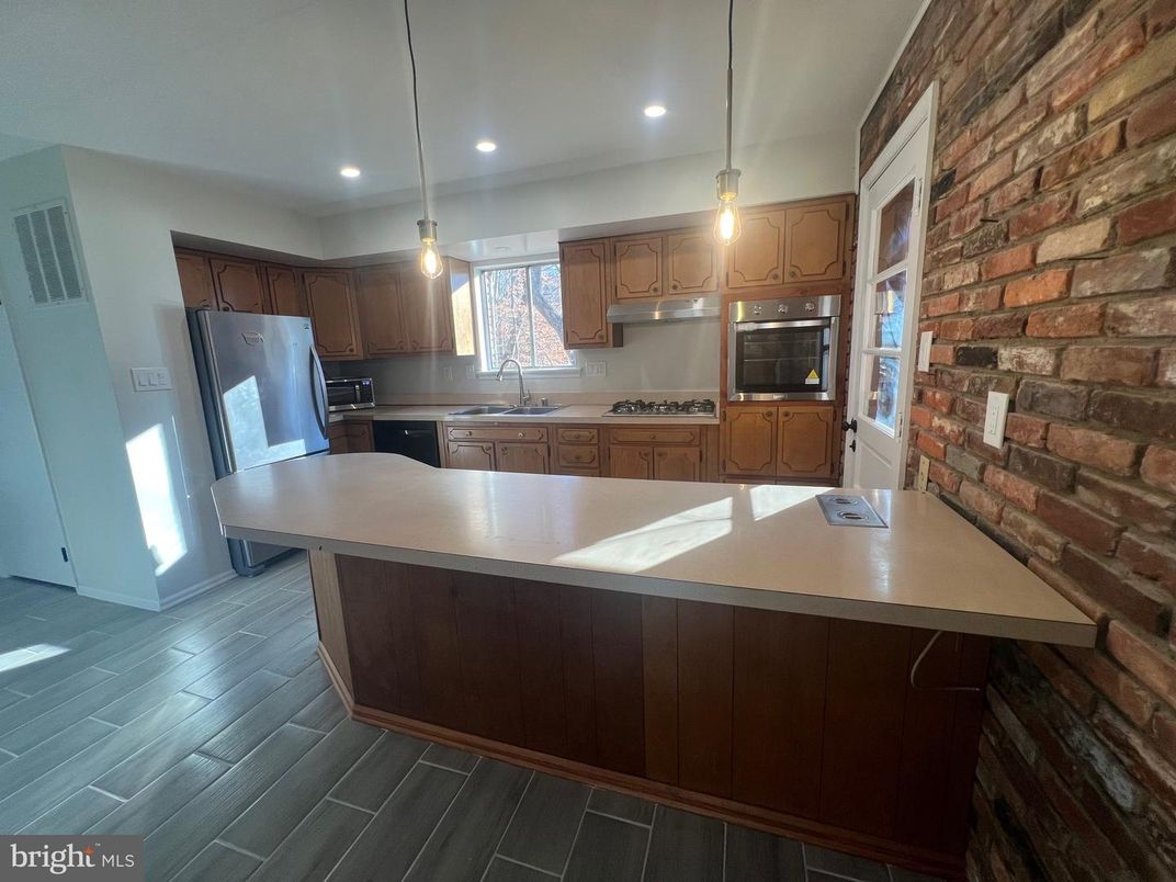 Interior, Kitchen, Pendant Lights, Recessed Lighting, Stainless Steel Appliances, Stone Walls, Wood Texture Flooring