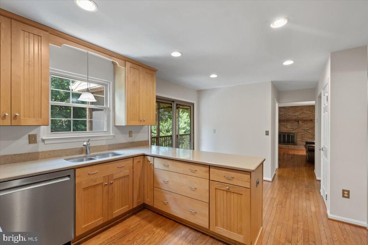Fireplace, Interior, Kitchen, Pendant Lights, Recessed Lighting, Stainless Steel Appliances, Stone Walls, Wood Texture Flooring