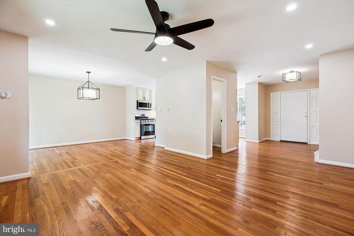 Empty room, Interior, Kitchen, Pendant Lights, Recessed Lighting, Stainless Steel Appliances, Wood Texture Flooring