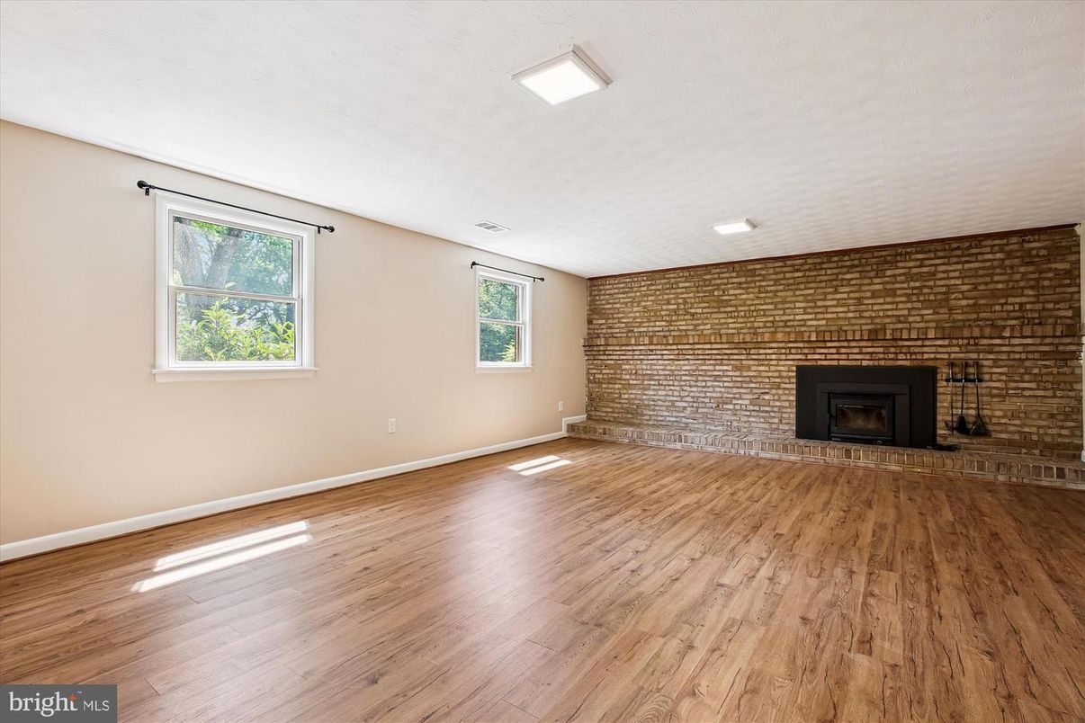 Empty room, Fireplace, Interior, Recessed Lighting, Stone Walls, Wood Texture Flooring