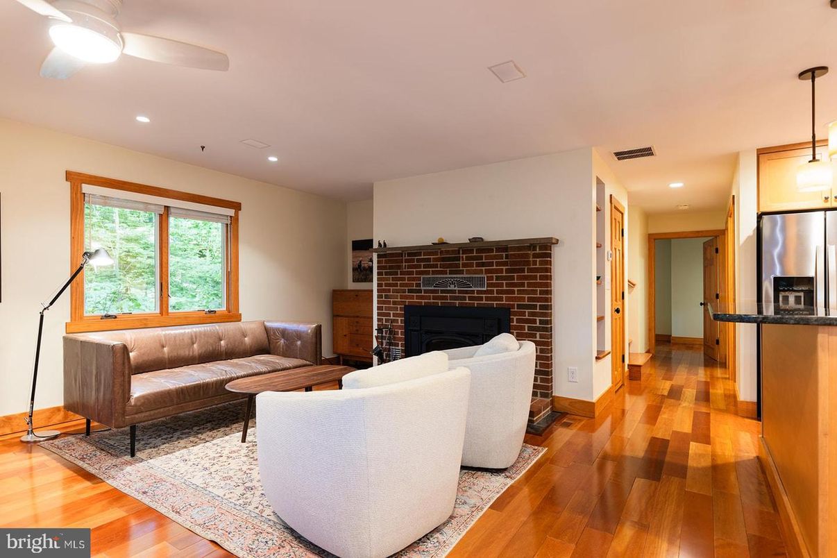 Fireplace, Interior, Kitchen, Living room, Pendant Lights, Recessed Lighting, Stainless Steel Appliances, Stone Walls, Wood Texture Flooring