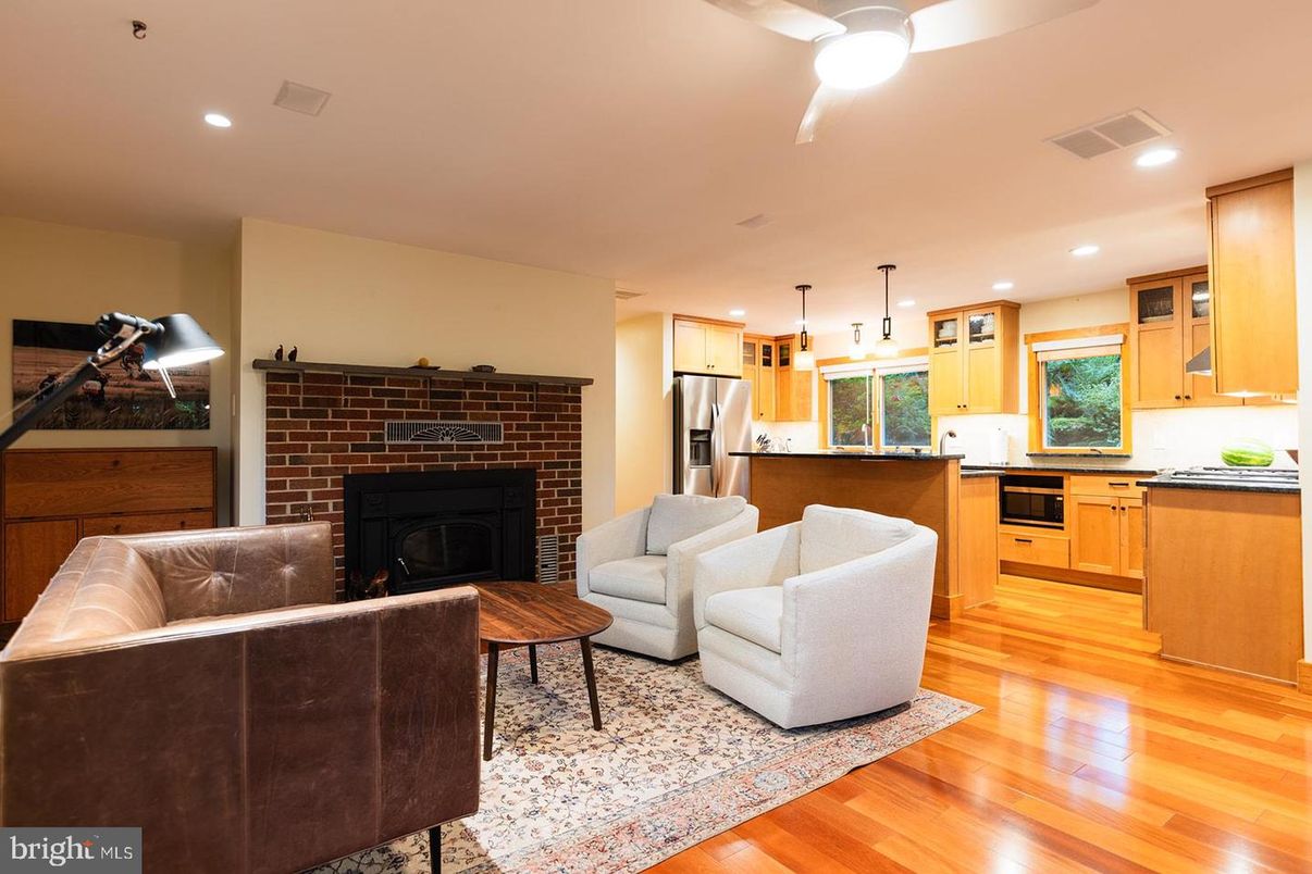Fireplace, Interior, Kitchen, Living room, Pendant Lights, Recessed Lighting, Stainless Steel Appliances, Stone Walls, Wood Texture Flooring