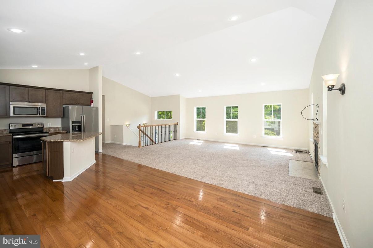 Empty room, Interior, Kitchen, Recessed Lighting, Stainless Steel Appliances, Wood Texture Flooring