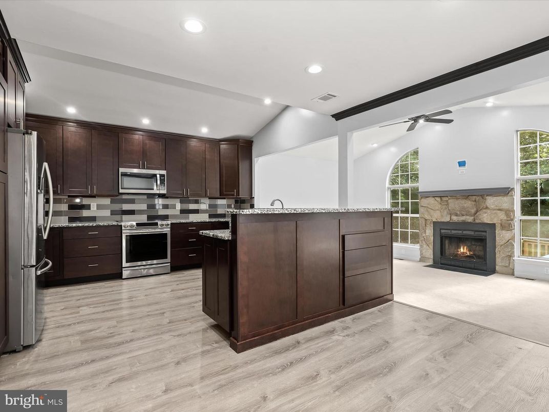 Fireplace, Interior, Kitchen, Recessed Lighting, Stainless Steel Appliances, Wood Texture Flooring