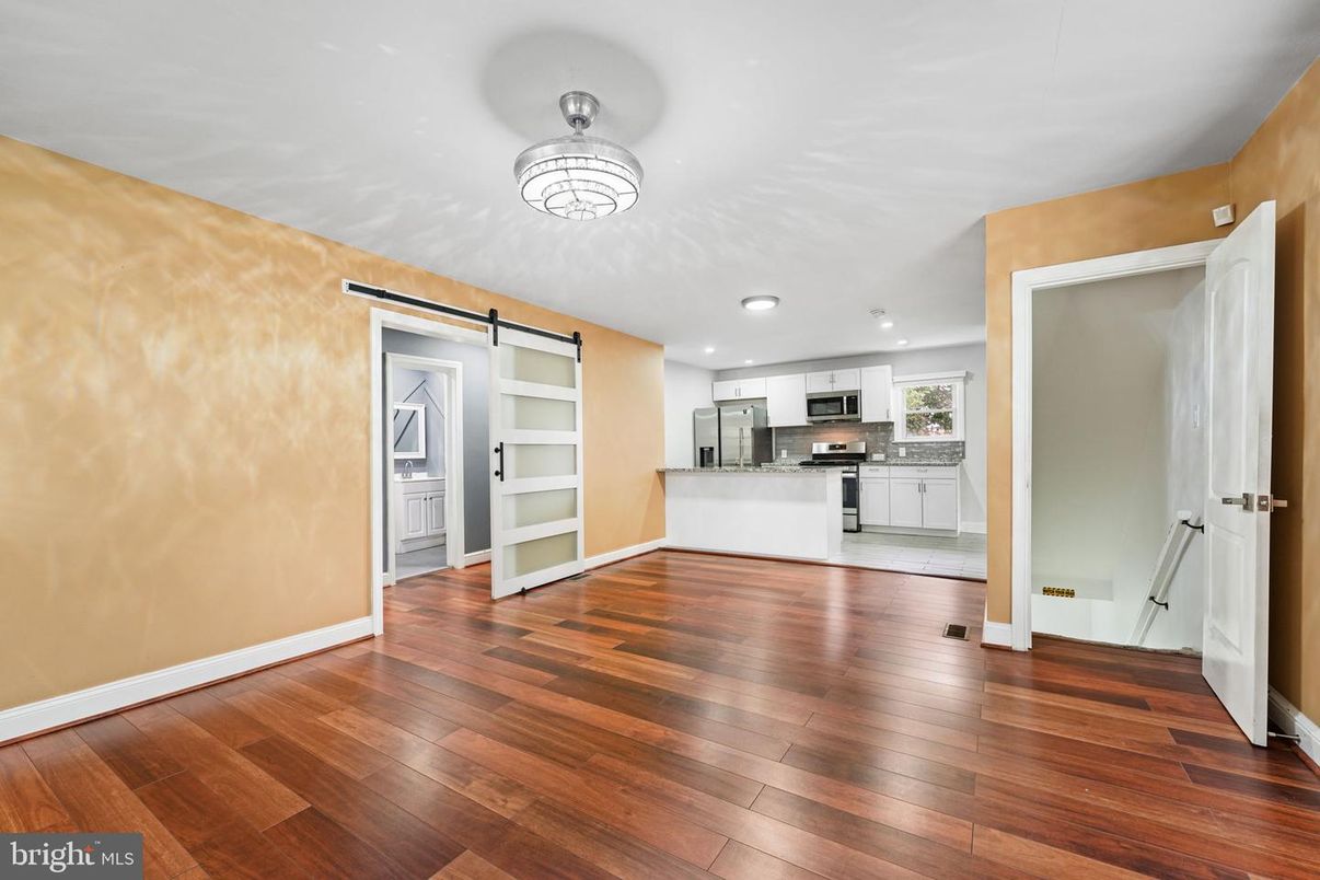 Empty room, Interior, Kitchen, Recessed Lighting, Stainless Steel Appliances, Wood Texture Flooring