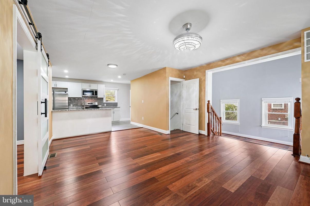 Empty room, Interior, Kitchen, Recessed Lighting, Stainless Steel Appliances, Wood Texture Flooring