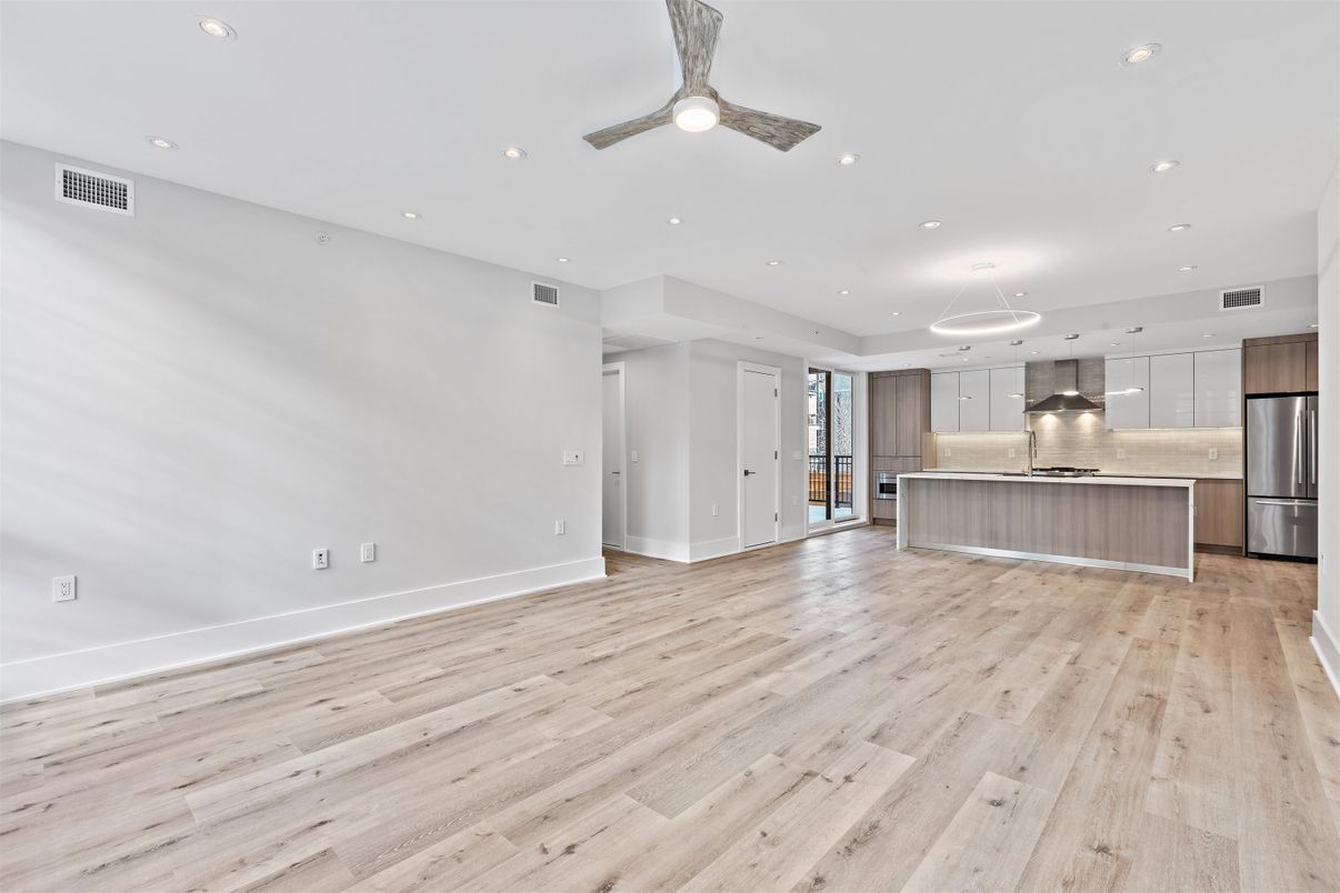 Empty room, Interior, Kitchen, Pendant Lights, Recessed Lighting, Stainless Steel Appliances, Wood Texture Flooring