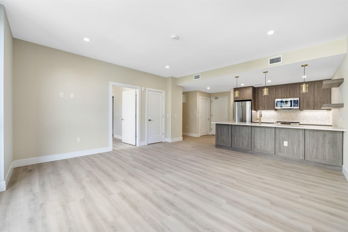 Empty room, Interior, Kitchen, Pendant Lights, Recessed Lighting, Stainless Steel Appliances, Wood Texture Flooring
