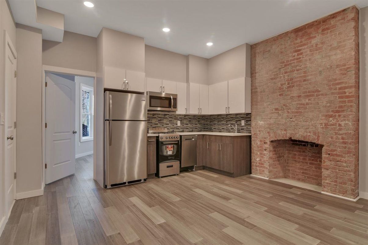 Fireplace, Interior, Kitchen, Recessed Lighting, Stainless Steel Appliances, Stone Walls, Wood Texture Flooring