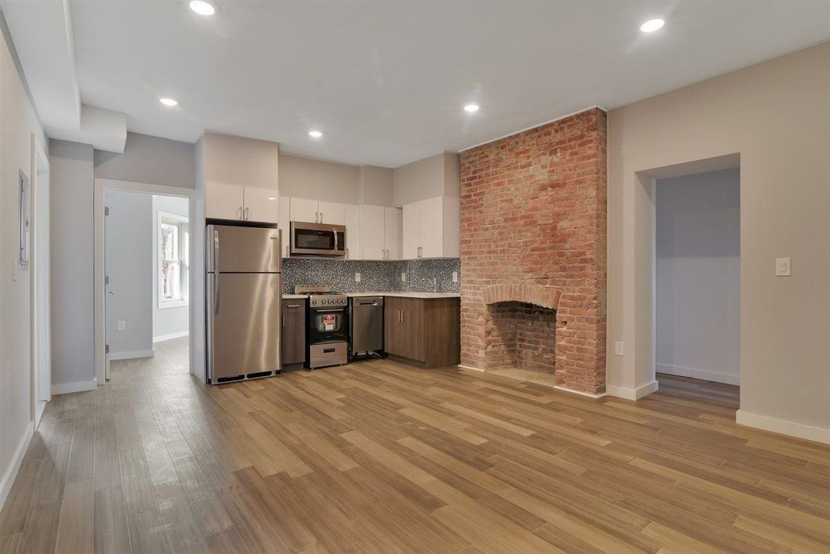 Fireplace, Interior, Kitchen, Recessed Lighting, Stainless Steel Appliances, Stone Walls, Wood Texture Flooring