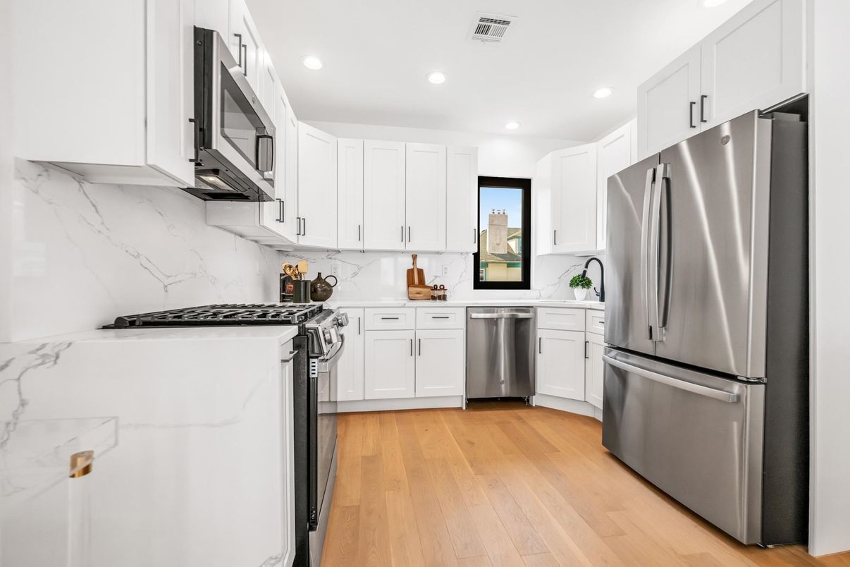 Interior, Kitchen, Marble Walls, Recessed Lighting, Stainless Steel Appliances, Wood Texture Flooring