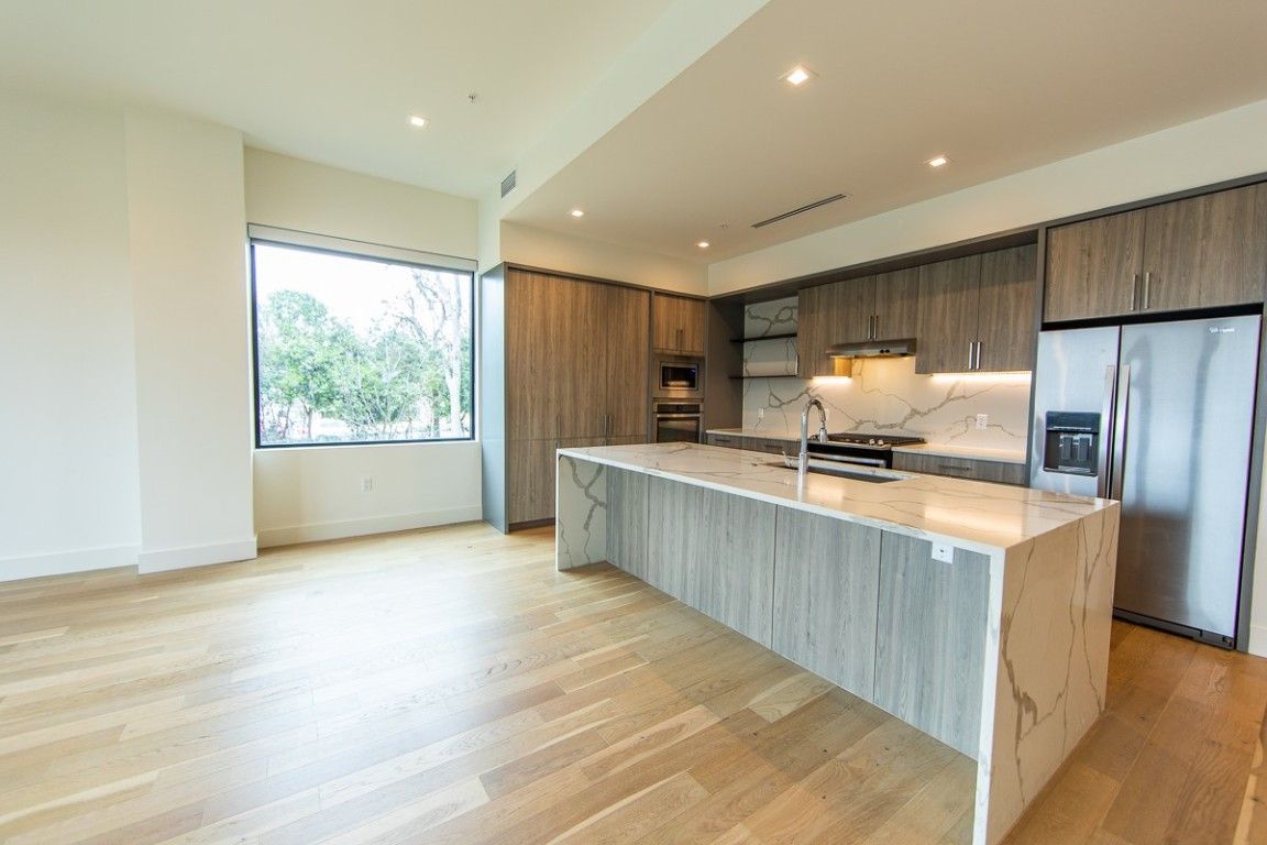 Interior, Kitchen, Marble Walls, Recessed Lighting, Stainless Steel Appliances, Wood Texture Flooring