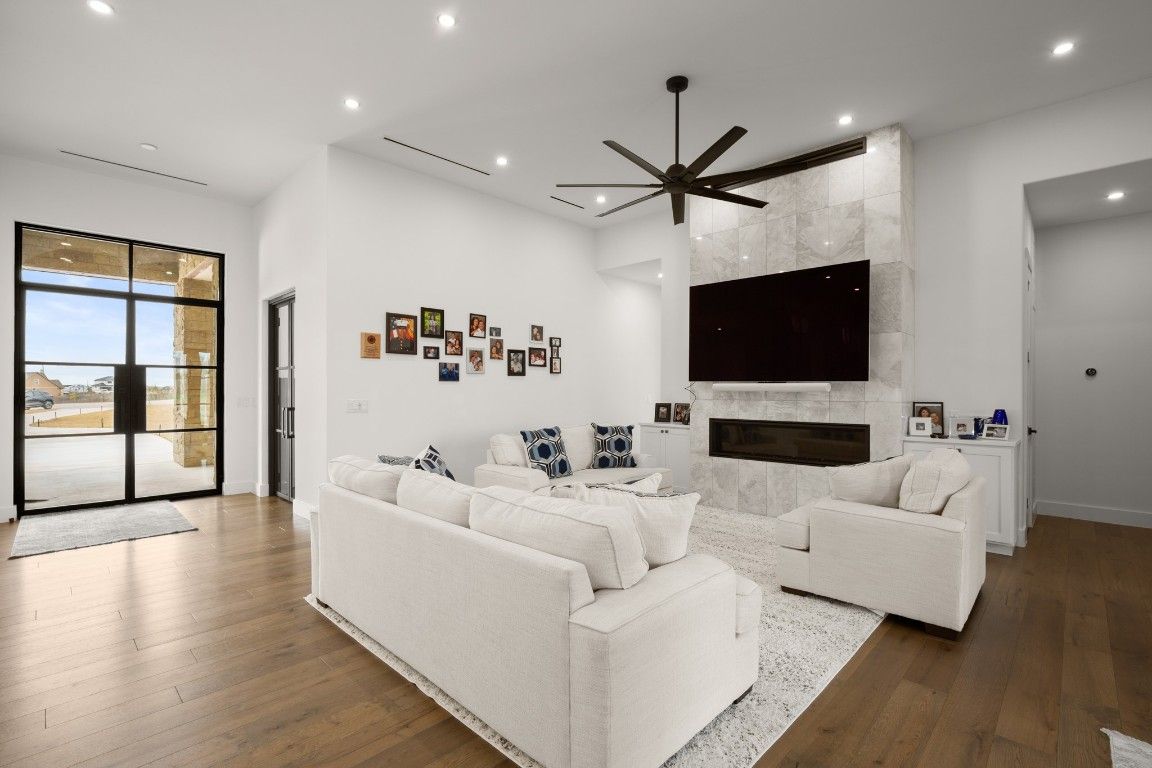 Fireplace, Interior, Living room, Marble Walls, Pendant Lights, Recessed Lighting, Wood Texture Flooring