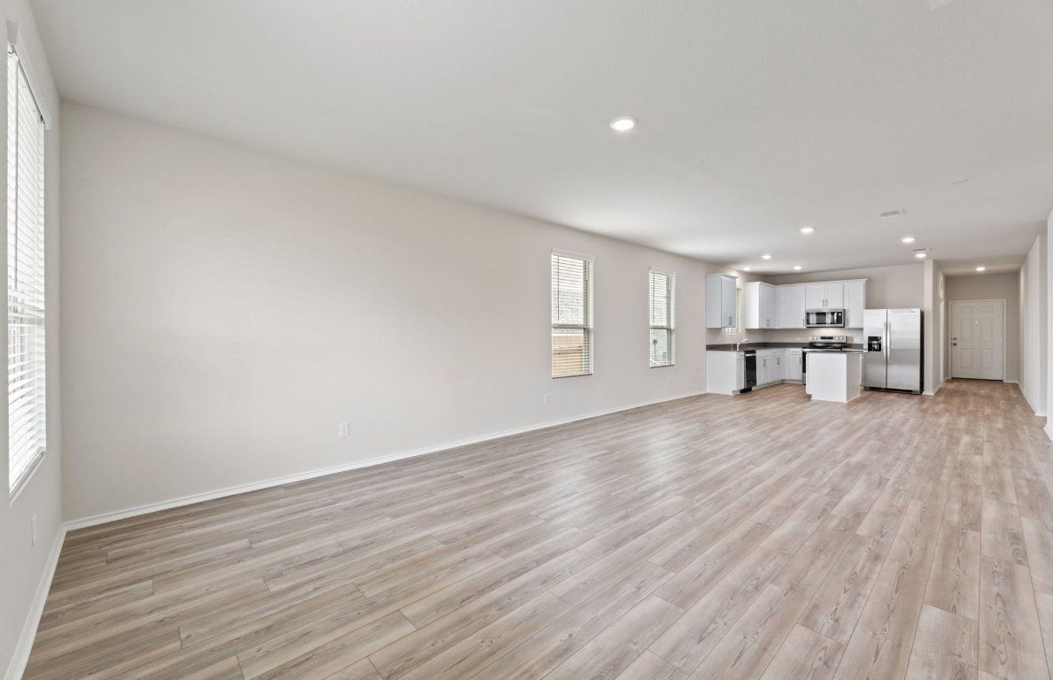 Empty room, Interior, Kitchen, Recessed Lighting, Stainless Steel Appliances, Wood Texture Flooring