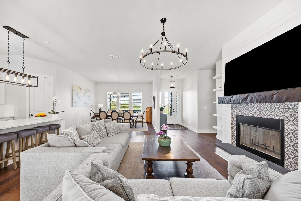 Chandelier, Dining room, Fireplace, Interior, Living room, Pendant Lights, Recessed Lighting, Wood Texture Flooring