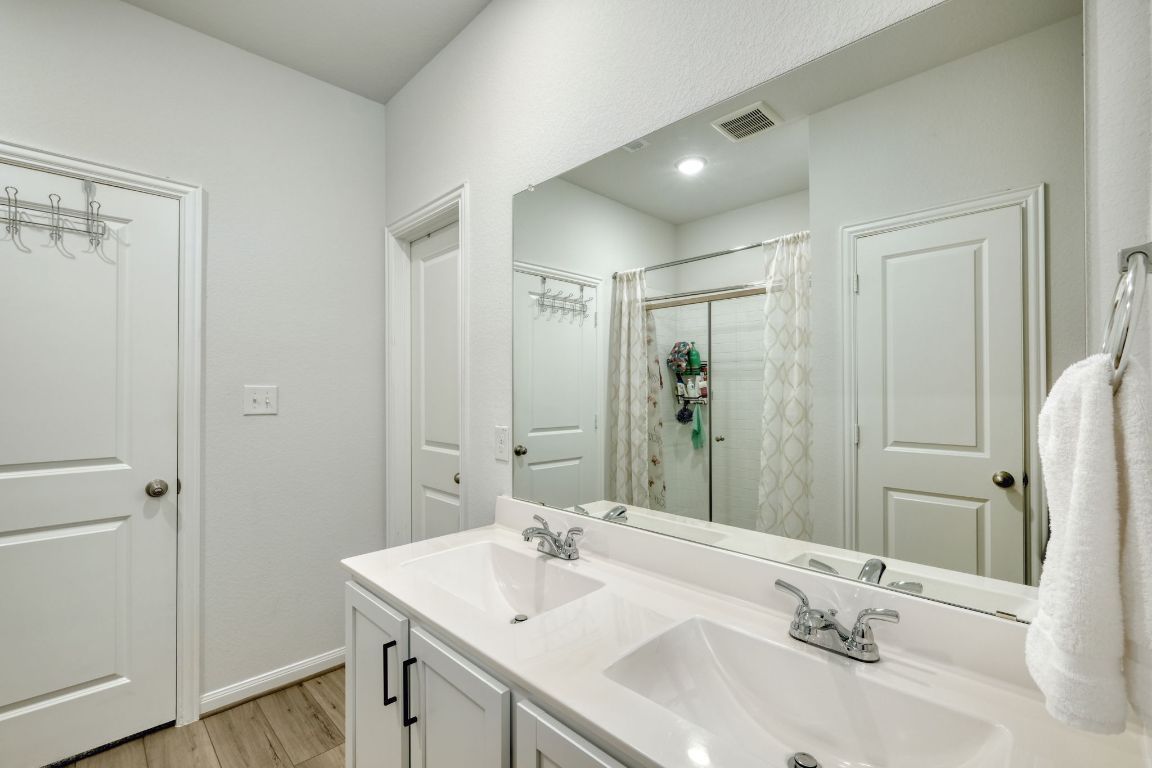 Bathroom, Dual Sink Vanities, Glass Shower, Interior, Recessed Lighting, Wood Texture Flooring