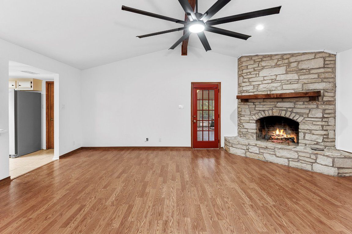 Empty room, Fireplace, Interior, Recessed Lighting, Stone Walls, Wood Texture Flooring
