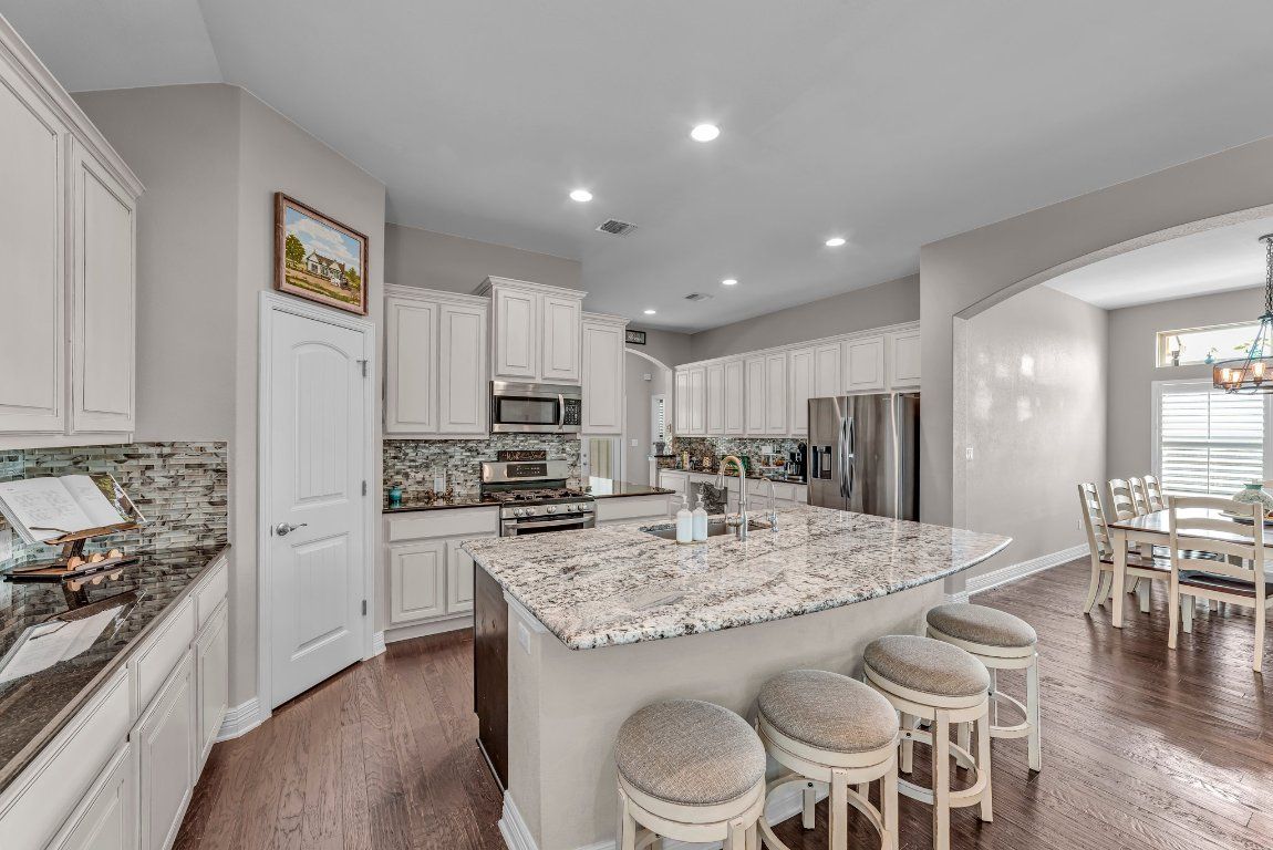 Chandelier, Dining room, Interior, Kitchen, Recessed Lighting, Stainless Steel Appliances, Wood Texture Flooring