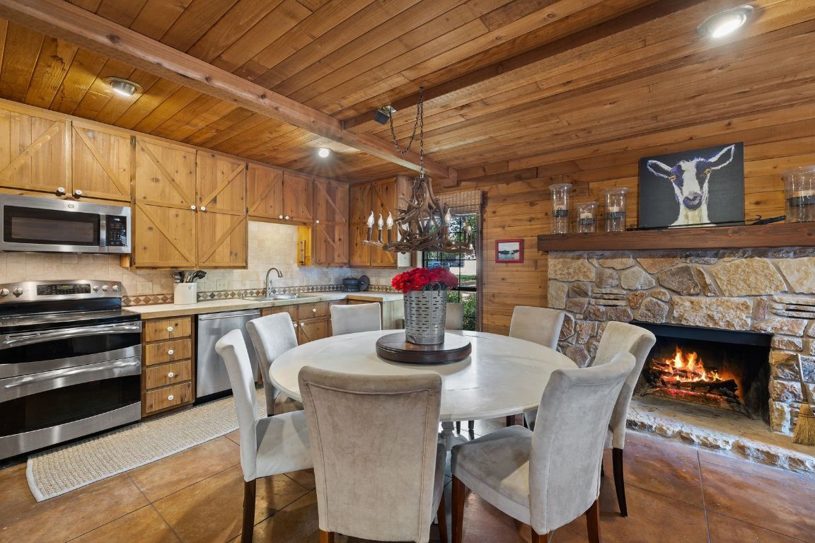 Chandelier, Dining room, Fireplace, Interior, Kitchen, Recessed Lighting, Stainless Steel Appliances, Wooden Beams, Wooden Ceilings, Wooden Walls