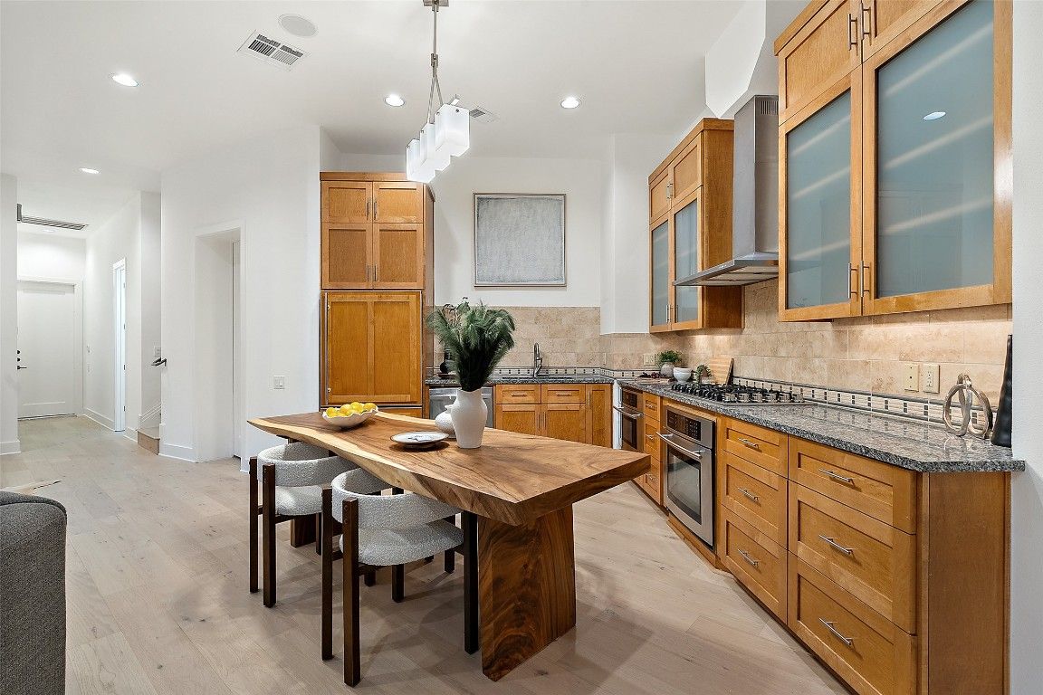 Dining room, Interior, Kitchen, Pendant Lights, Recessed Lighting, Stainless Steel Appliances, Wood Texture Flooring