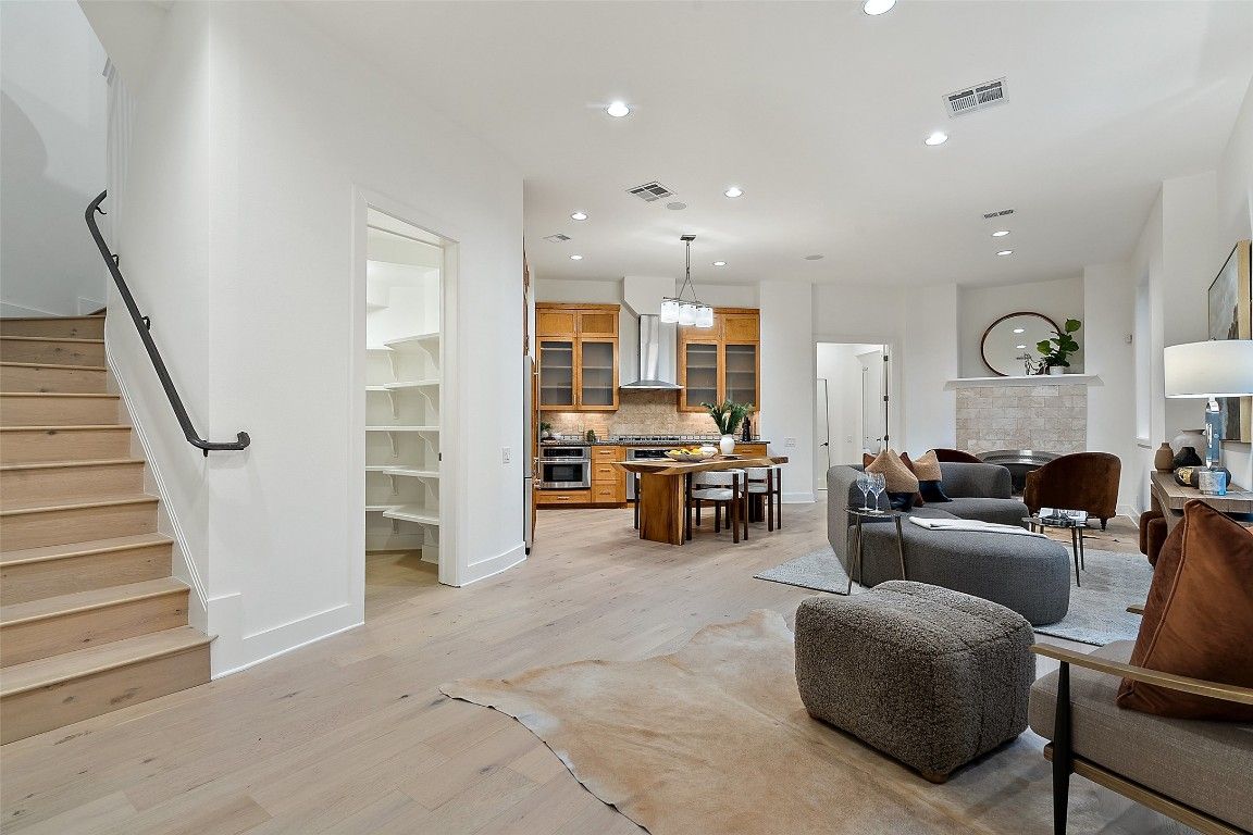 Dining room, Fireplace, Interior, Kitchen, Living room, Pendant Lights, Recessed Lighting, Stainless Steel Appliances, Wood Texture Flooring