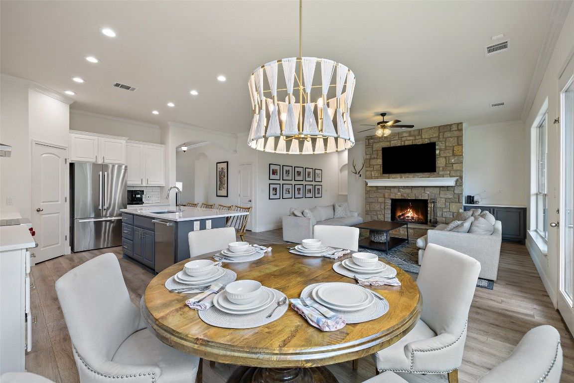 Dining room, Fireplace, Interior, Kitchen, Living room, Pendant Lights, Recessed Lighting, Stainless Steel Appliances, Stone Walls, Wood Texture Flooring