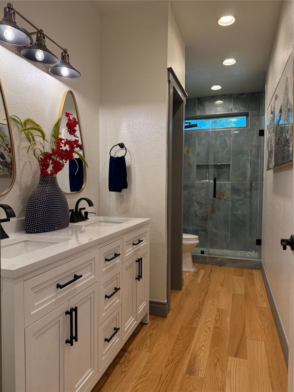 Bathroom, Dual Sink Vanities, Glass Shower, Interior, Recessed Lighting, Wood Texture Flooring