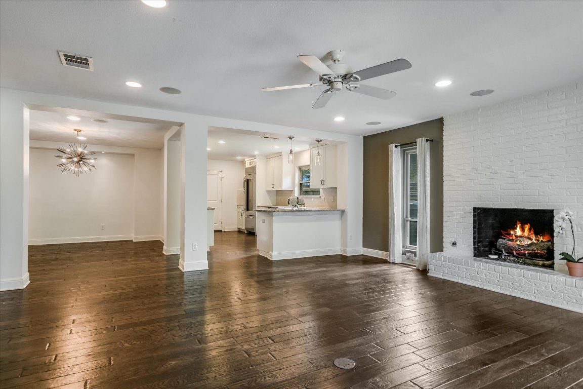Empty room, Fireplace, Interior, Kitchen, Pendant Lights, Recessed Lighting, Stone Walls, Wood Texture Flooring