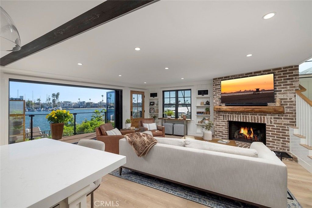 Fireplace, Interior, Living room, Recessed Lighting, Stone Walls, Water, Wood Texture Flooring