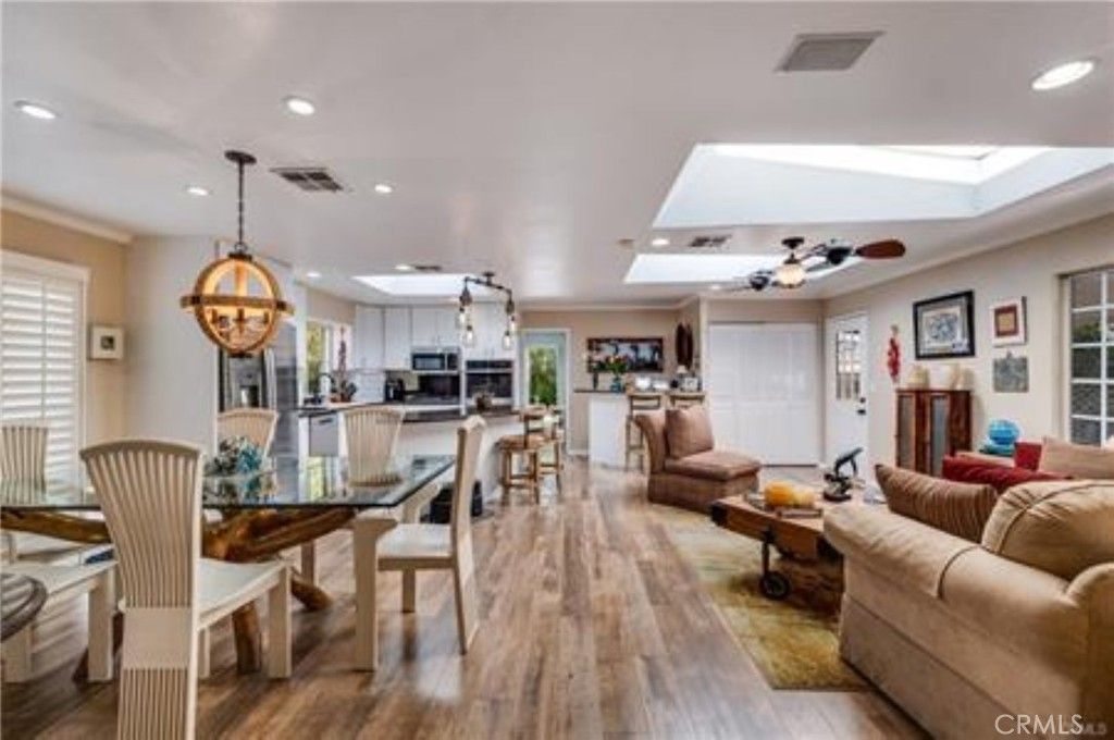 Chandelier, Dining room, Interior, Kitchen, Living room, Pendant Lights, Recessed Lighting, Stainless Steel Appliances, Wood Texture Flooring