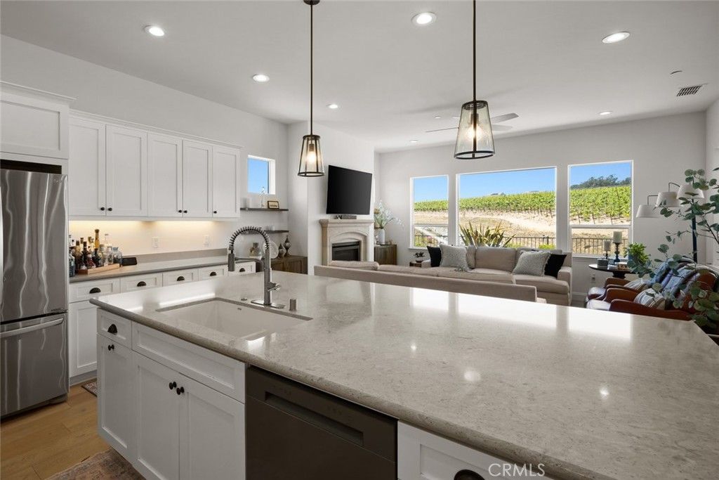 Fireplace, Interior, Kitchen, Living room, Pendant Lights, Recessed Lighting, Stainless Steel Appliances, Wood Texture Flooring
