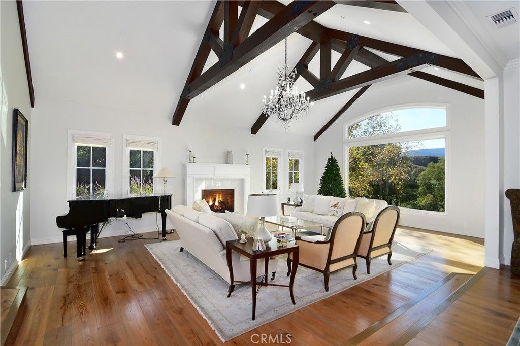 Chandelier, Fireplace, Interior, Living room, Piano, Recessed Lighting, Wooden Beams, Wood Texture Flooring