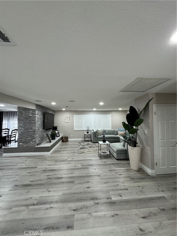 Fitness Equipment, Interior, Living room, Recessed Lighting, Stone Walls, Wood Texture Flooring
