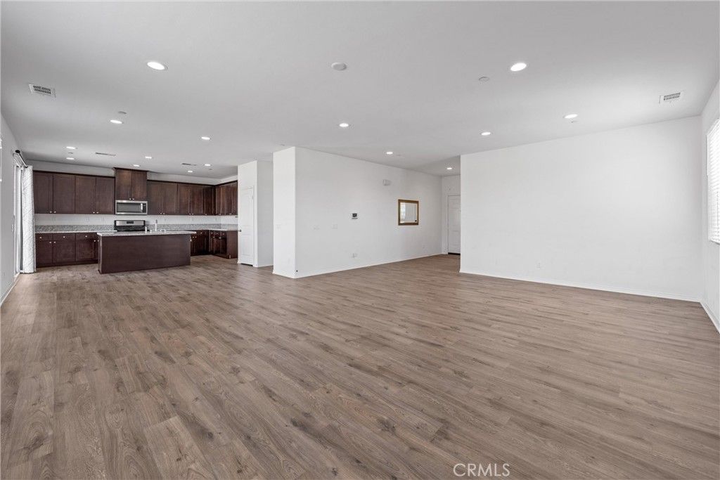 Empty room, Interior, Kitchen, Recessed Lighting, Stainless Steel Appliances, Wood Texture Flooring