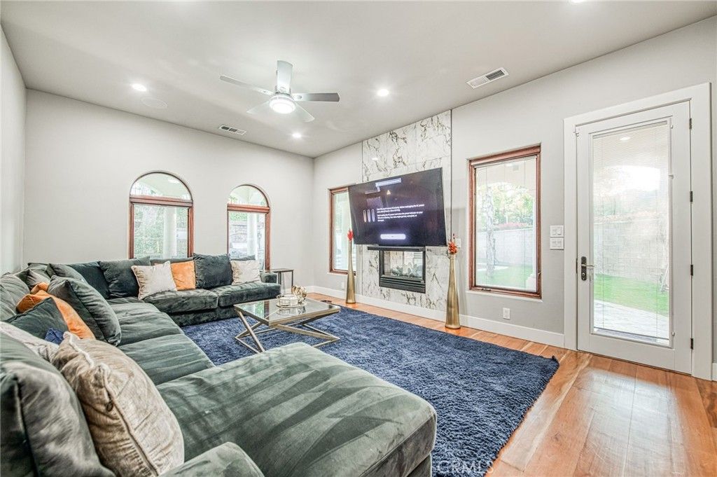Fireplace, Interior, Living room, Marble Walls, Recessed Lighting, Wood Texture Flooring