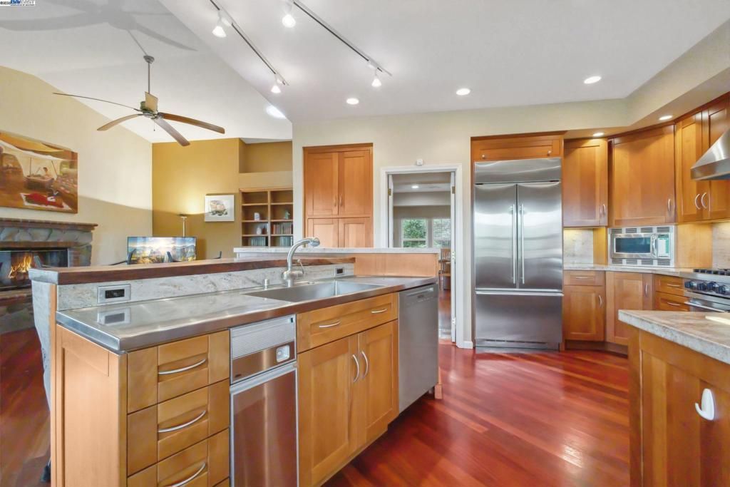 Fireplace, Interior, Kitchen, Recessed Lighting, Stainless Steel Appliances, Wood Texture Flooring