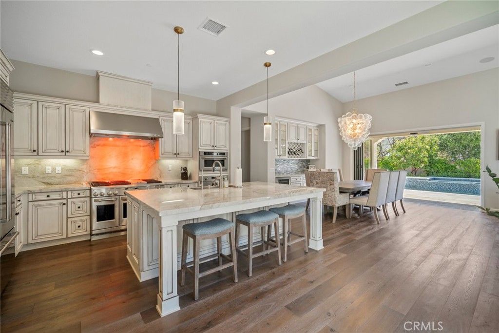 Chandelier, Dining room, Interior, Kitchen, Pendant Lights, Recessed Lighting, Stainless Steel Appliances, Wood Texture Flooring