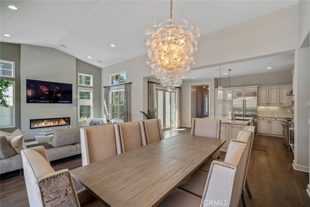 Chandelier, Dining room, Fireplace, Interior, Kitchen, Living room, Pendant Lights, Recessed Lighting, Stainless Steel Appliances, Wood Texture Flooring