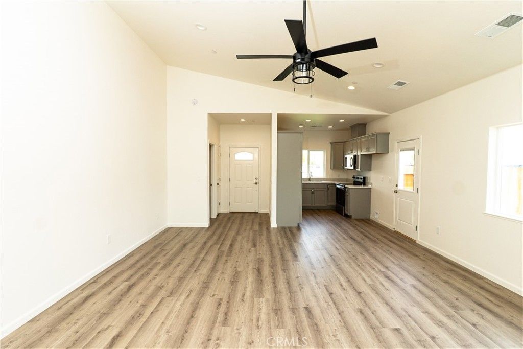 Empty room, Interior, Kitchen, Recessed Lighting, Stainless Steel Appliances, Wood Texture Flooring