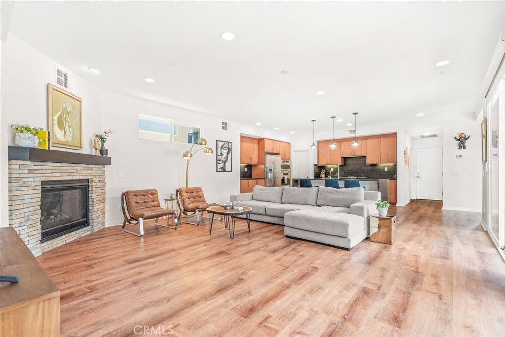 Fireplace, Interior, Kitchen, Living room, Pendant Lights, Recessed Lighting, Stainless Steel Appliances, Wood Texture Flooring
