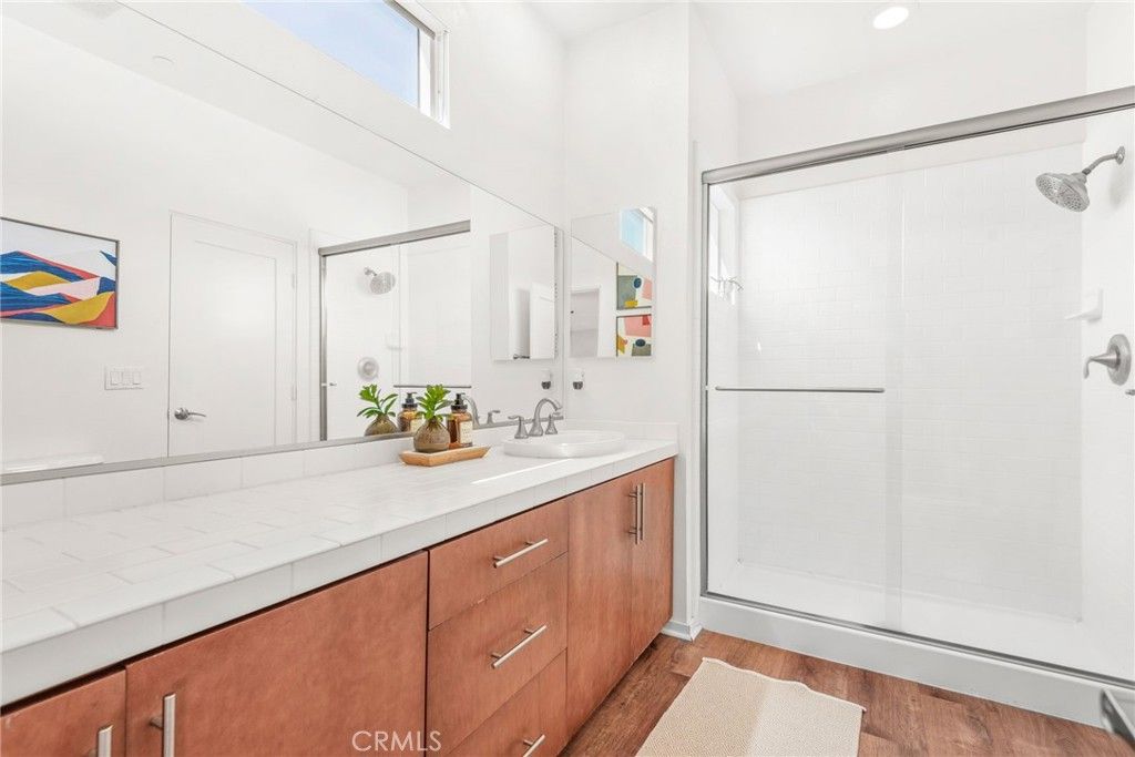 Bathroom, Dual Sink Vanities, Glass Shower, Interior, Recessed Lighting, Tile Countertops, Wood Texture Flooring
