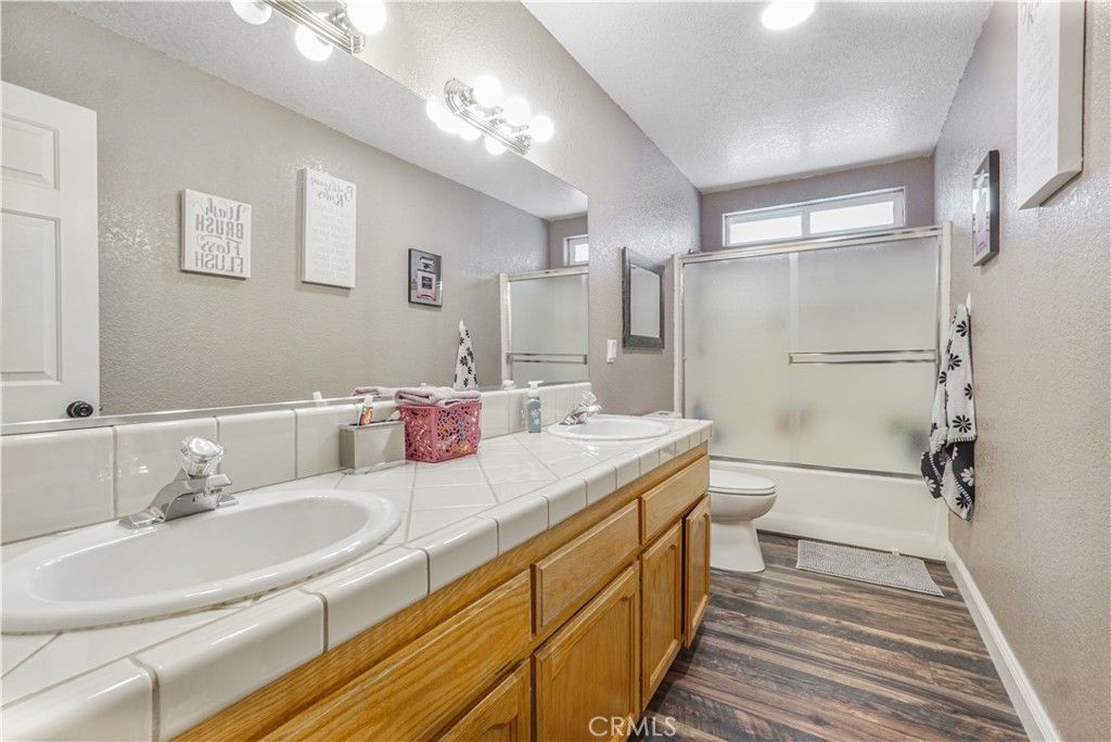 Bathroom, Dual Sink Vanities, Glass Shower, Interior, Recessed Lighting, Tile Countertops, Wood Texture Flooring